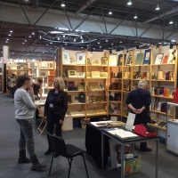 Leipziger Antiquariatsmesse: Besucherinnen unterhalten sich vor gefüllten Bücherregalen