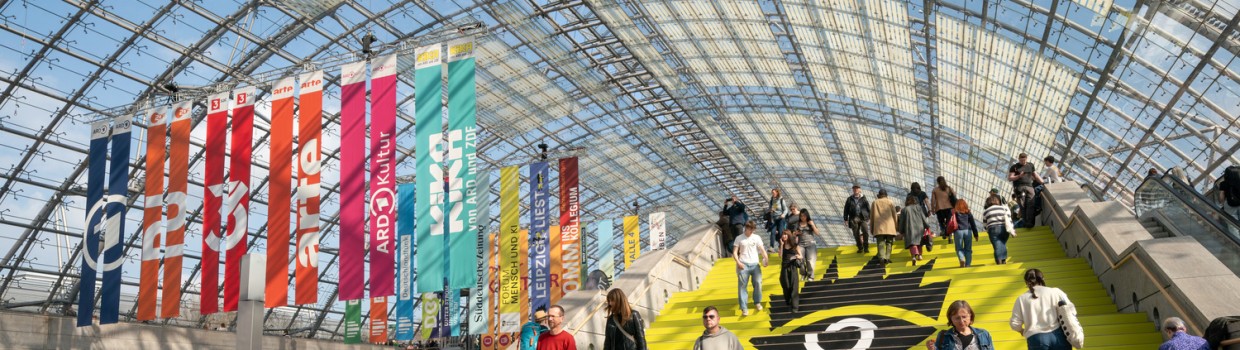 belebte Glashalle während der Leipziger Buchmesse mir fröhlichen Besucher:innen
