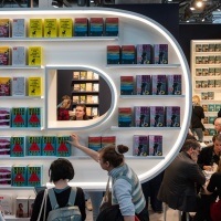 Impression of the exhibition area at the Leipzig Book Fair 2024 with exhibition stands and visitors