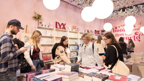 Visitors browse through books at the LYX booth 