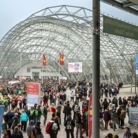 Exterior view of the glass hall at Leipzig Exhibition Center with many visitors during the Leipzig Book Fair 2025