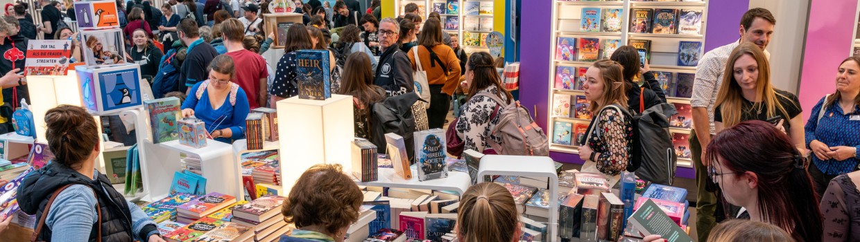 Impression of visitors browsing book tables at the Leipzig Book Fair 2025