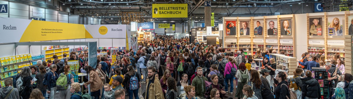 Crowded hall with Reclam, Suhrkamp and Insel publisher booths at Leipzig Book Fair 2026