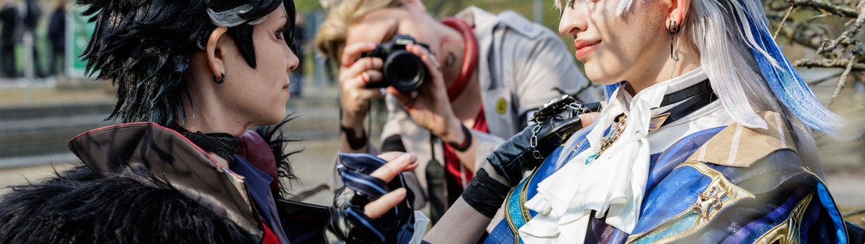 Two cosplayers in elaborate costumes are getting fotographed at Manga Comic Con 2026